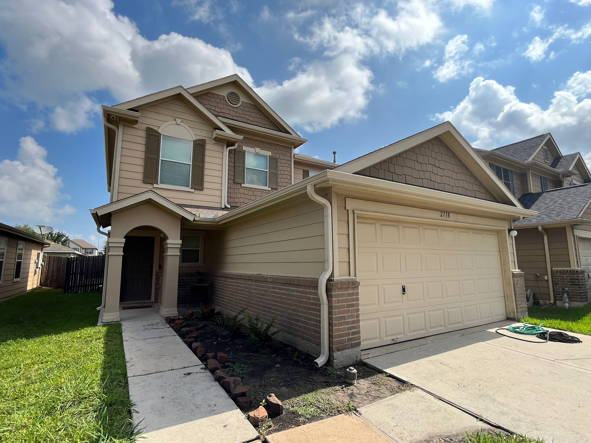 Finished two-story home with seamless gutters and downspout