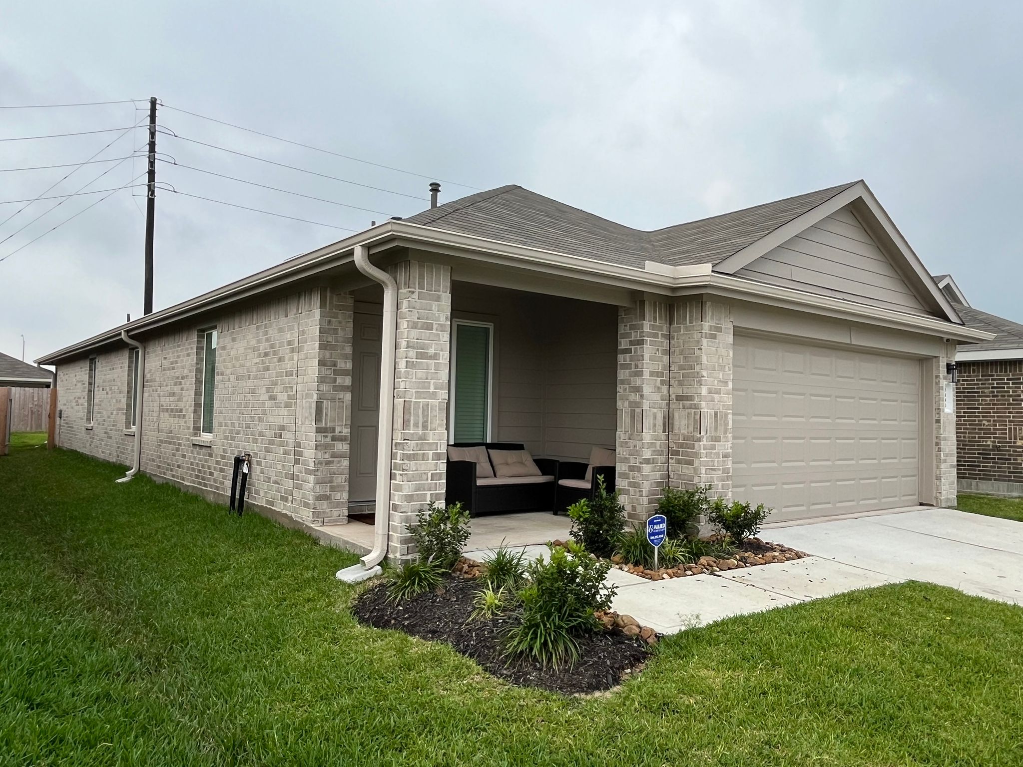 Finished brick ranch with white seamless gutters