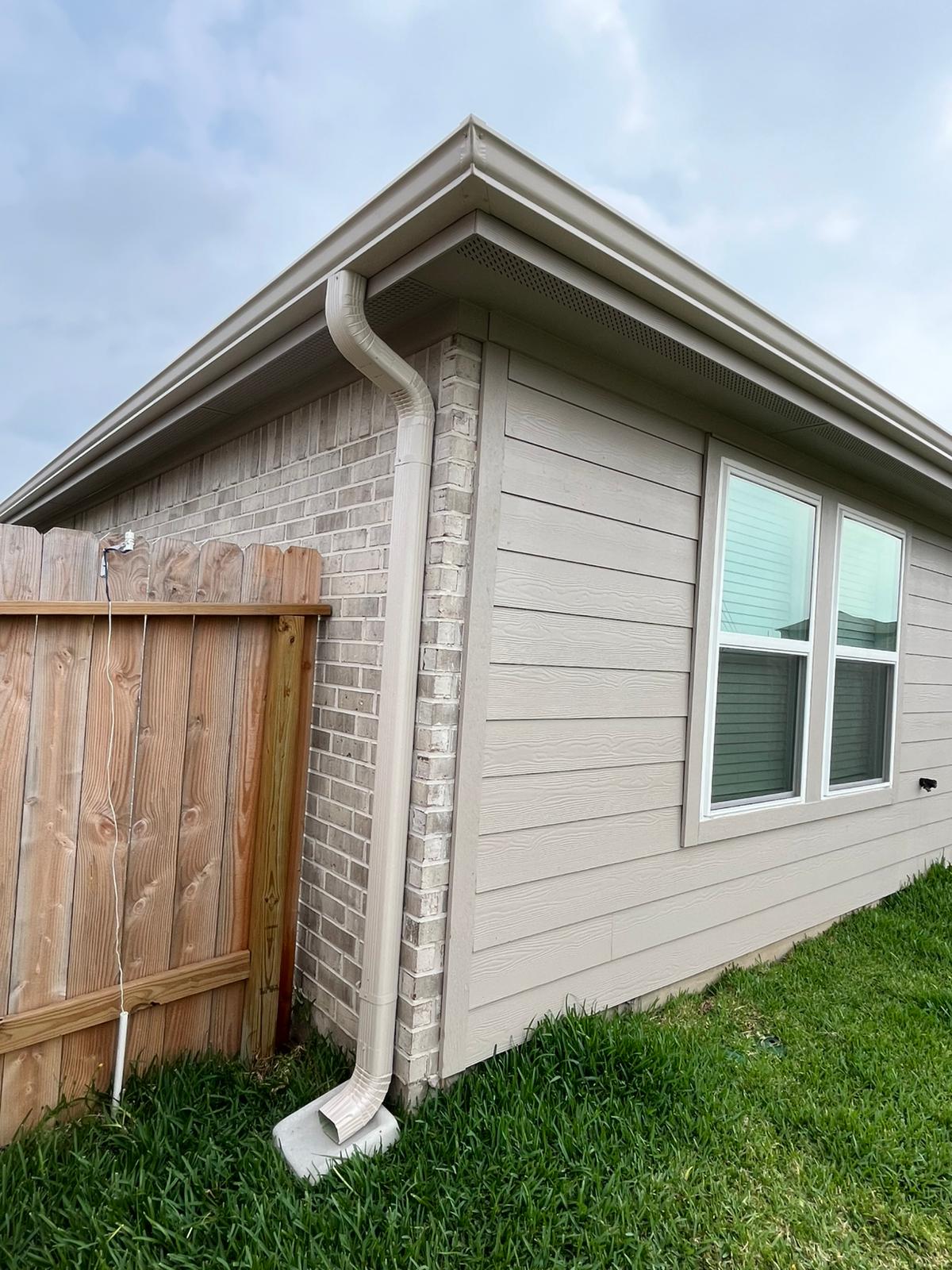 White downspout corner on a finished home