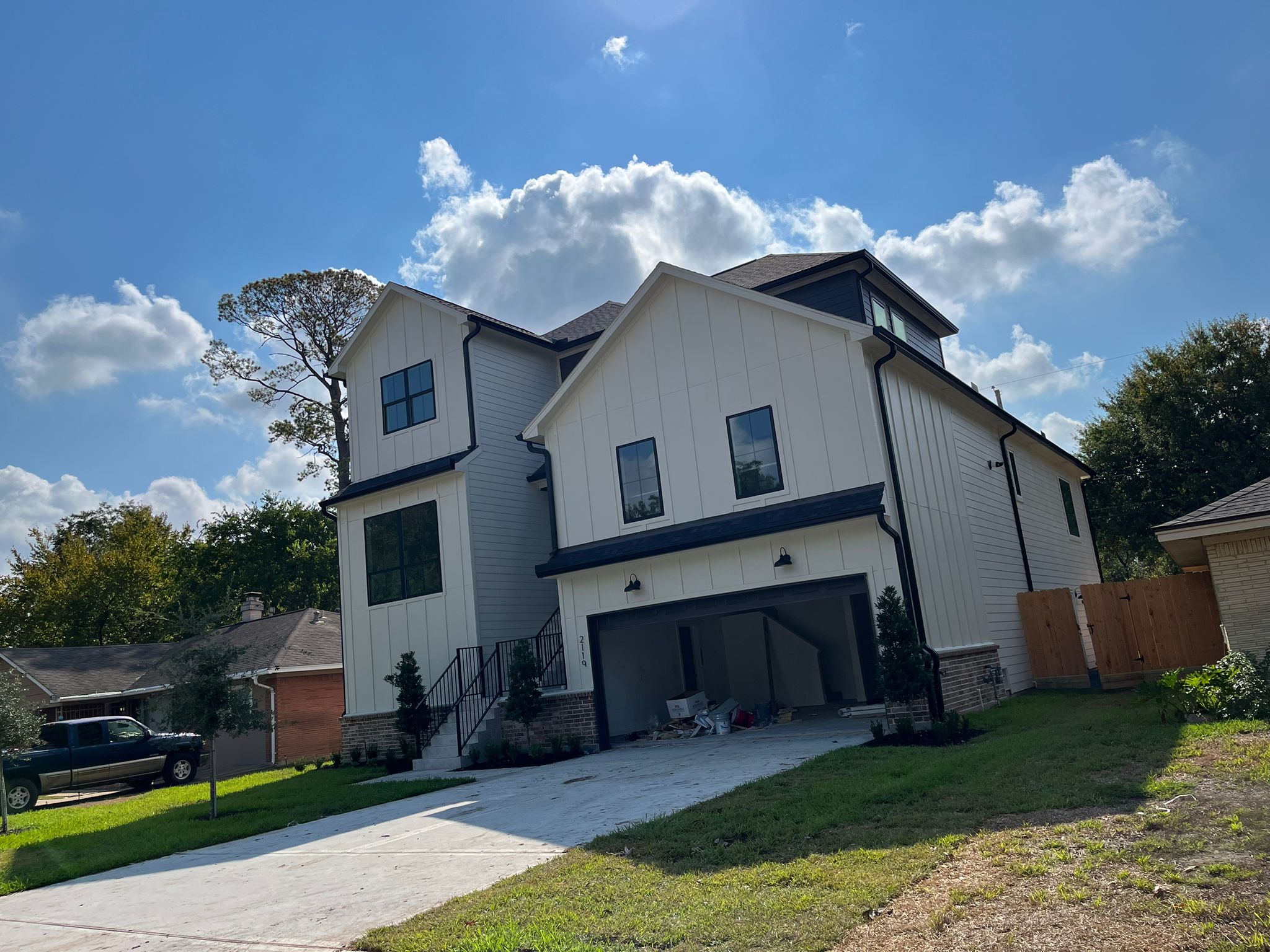 Finished two-story home with black seamless gutters