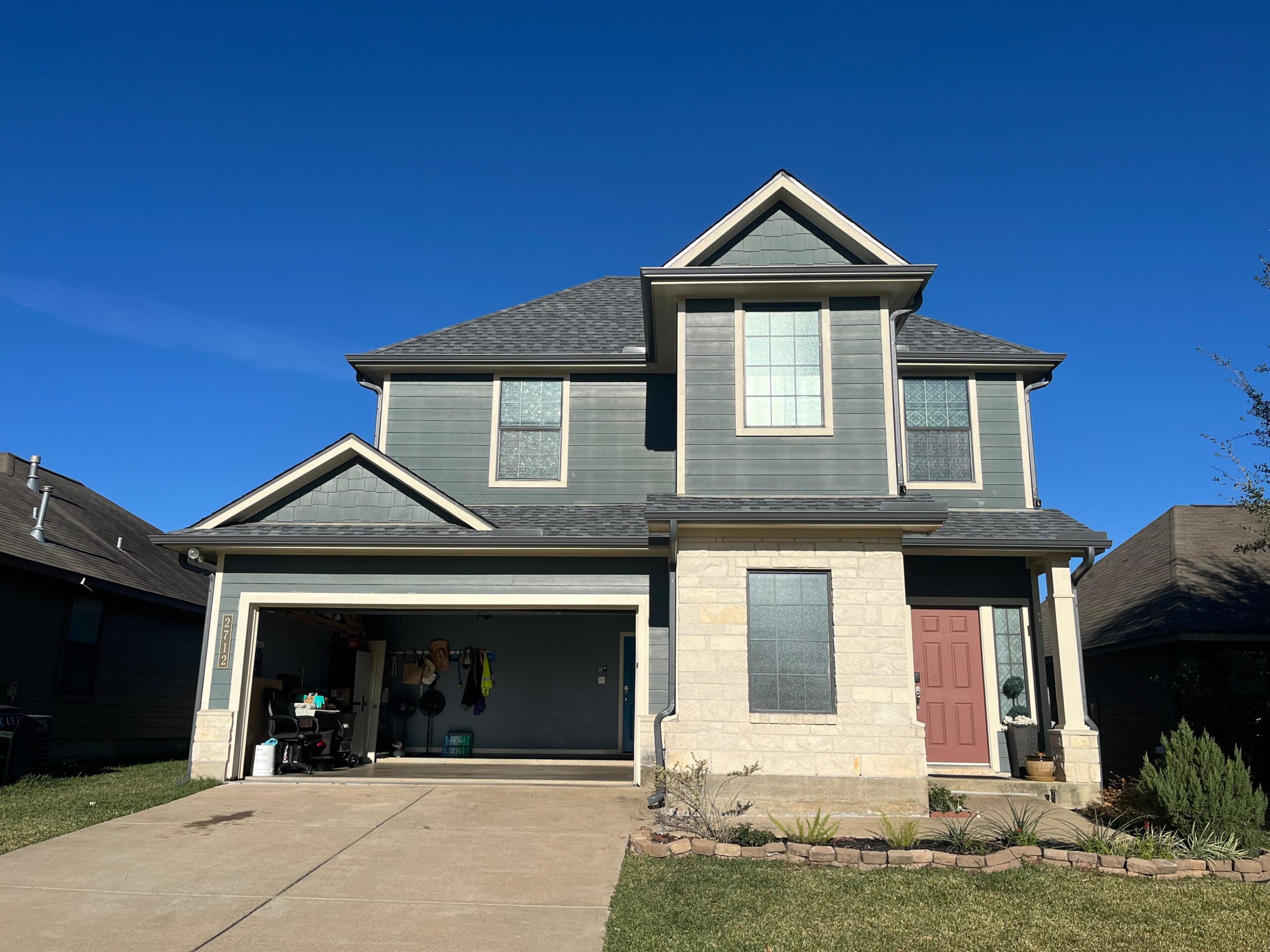 Finished two-story home with seamless gutters and downspout