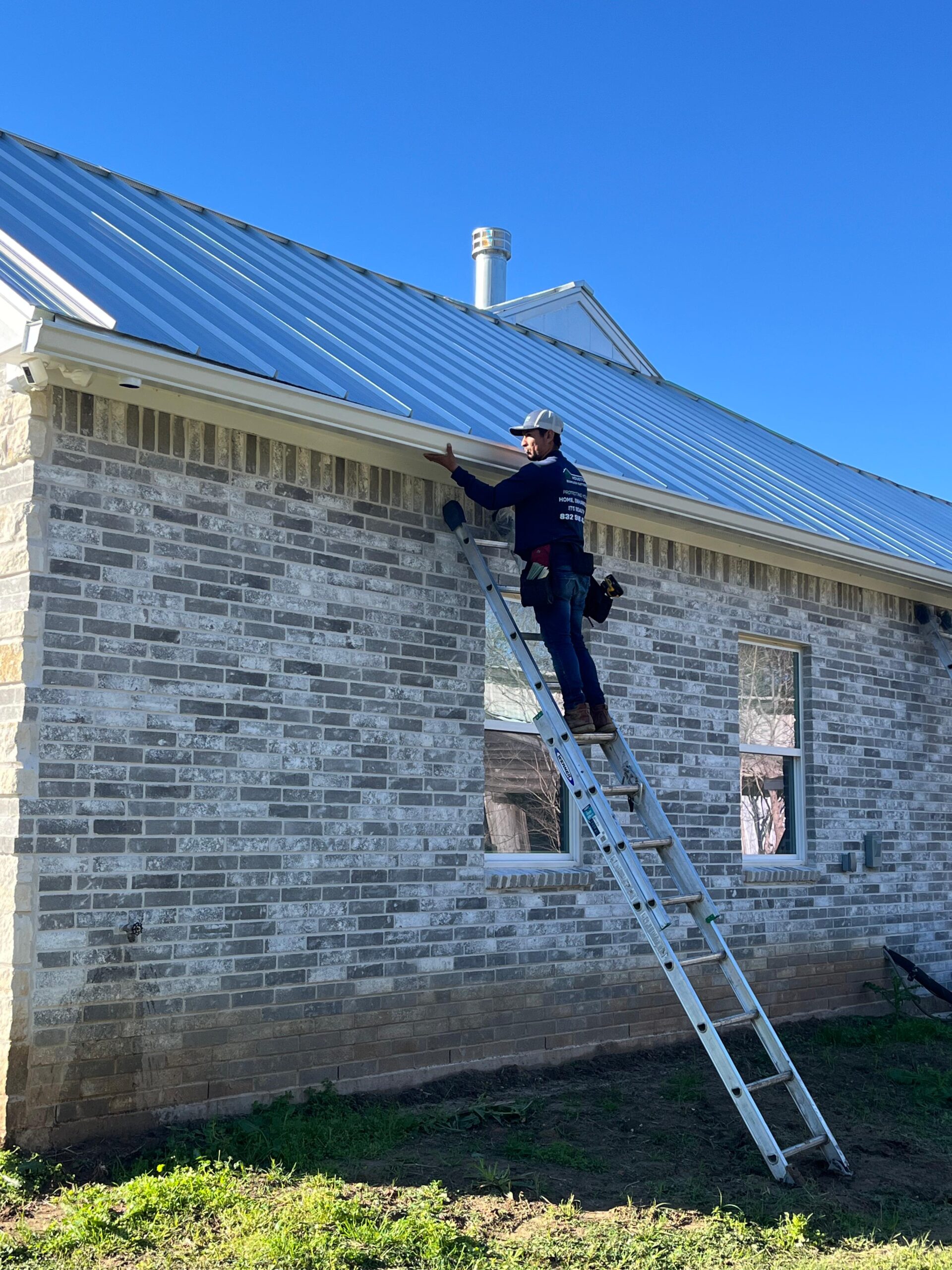 Alonzo installing white seamless gutters