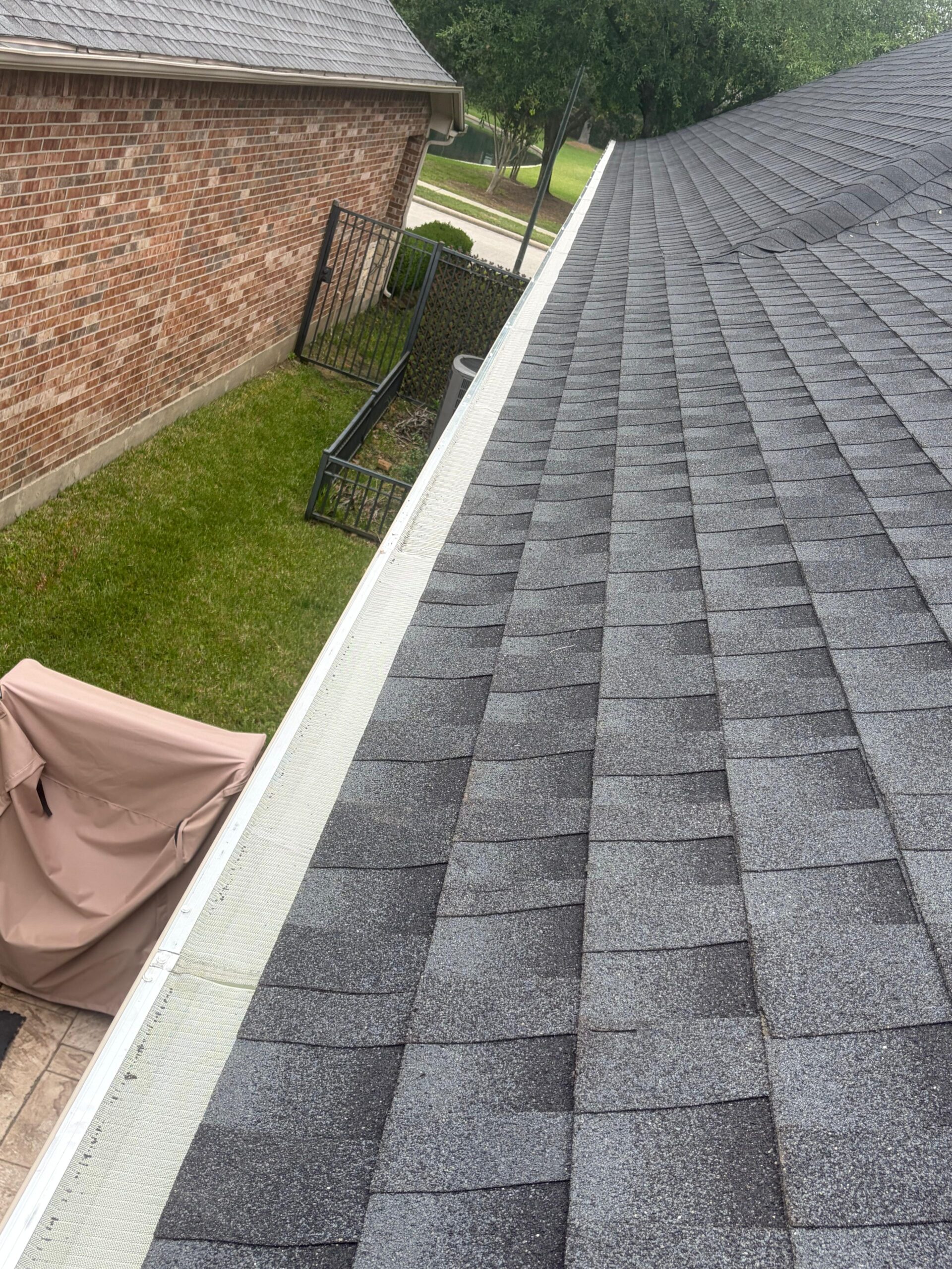 White seamless gutter line along a finished roofline